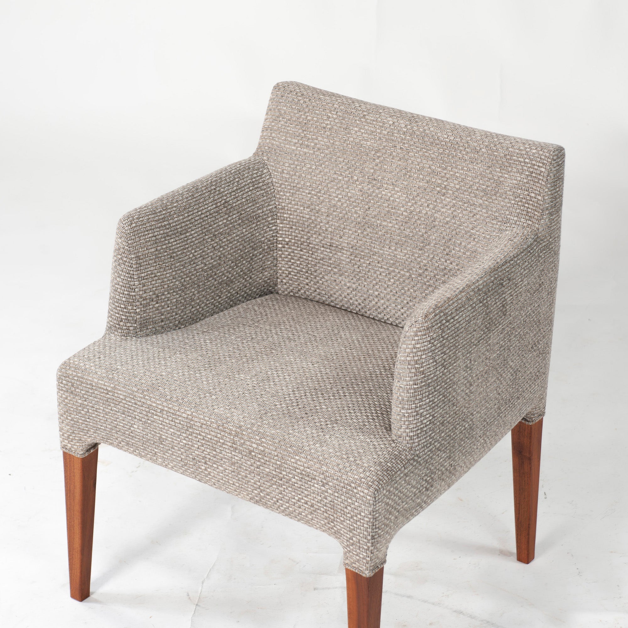 Ritzwell C-LINE armchair in walnut with an oil finish and fabric upholstery. Simple, Scandinavian modern design.