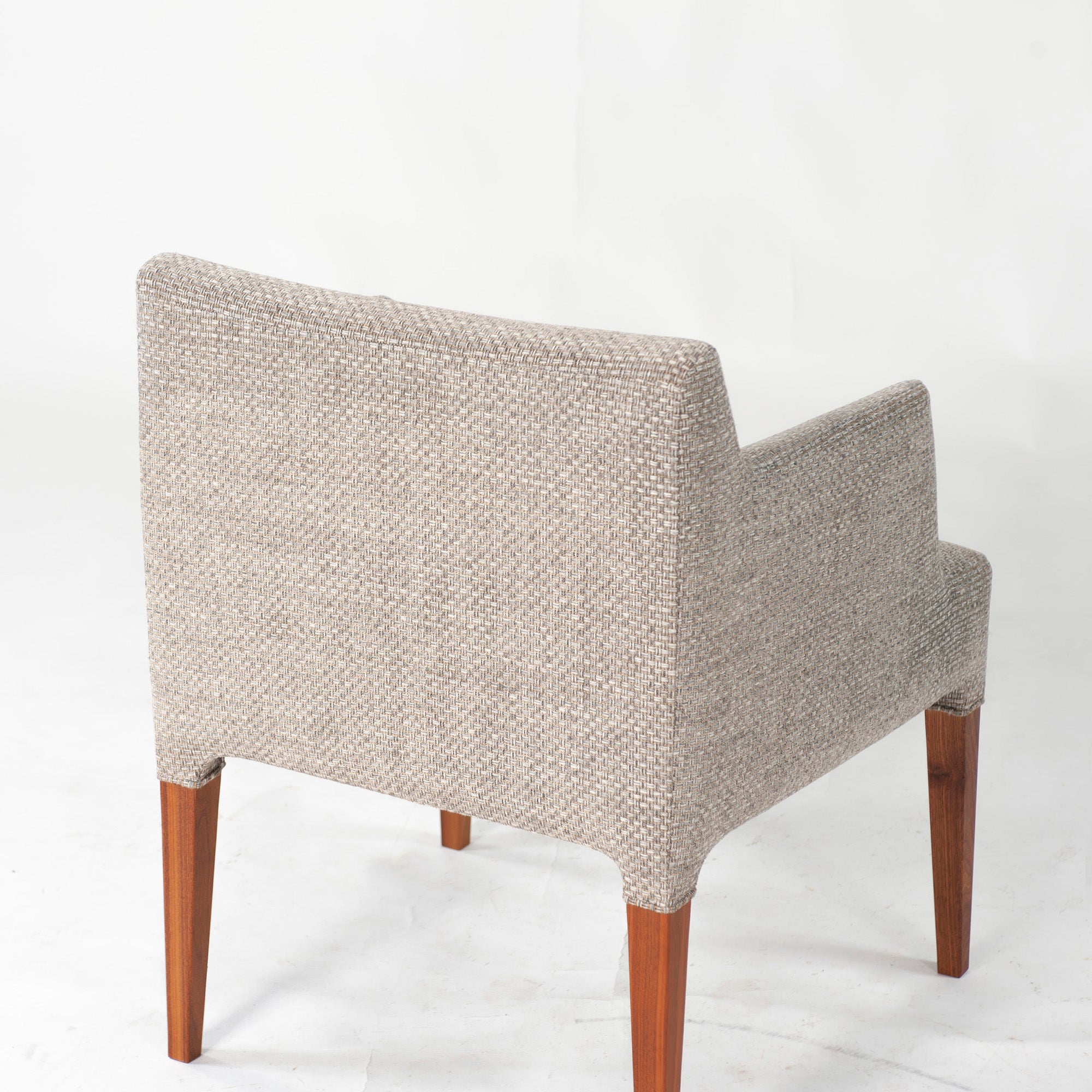 Ritzwell C-LINE armchair in walnut with an oil finish and fabric upholstery. Simple, Scandinavian modern design.