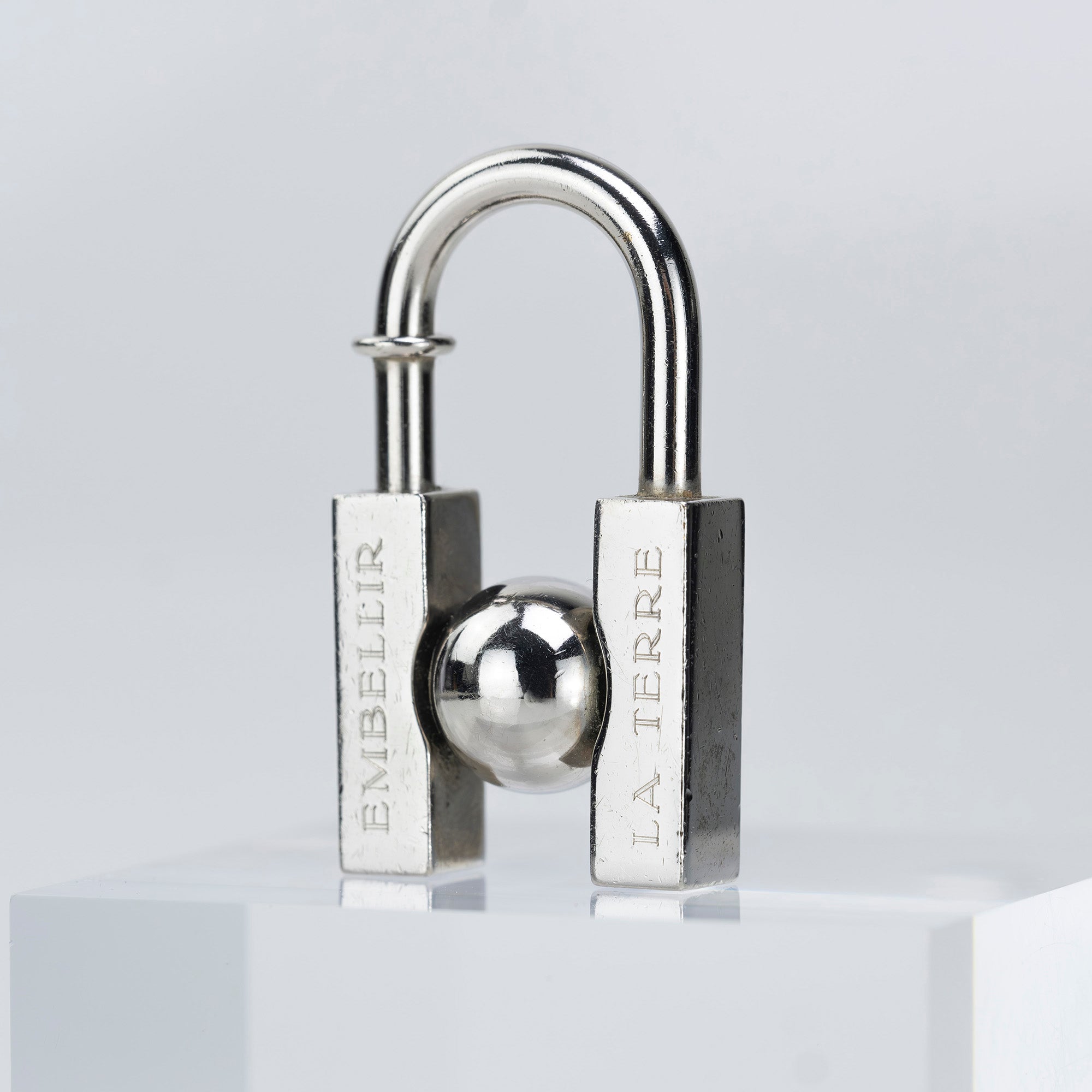 HERMES Padlock Charm 2001 Limited Edition "L'HOMME PEUT EMBELLIR LA TERRE/In Search of the Unknown Beauty of the Earth"