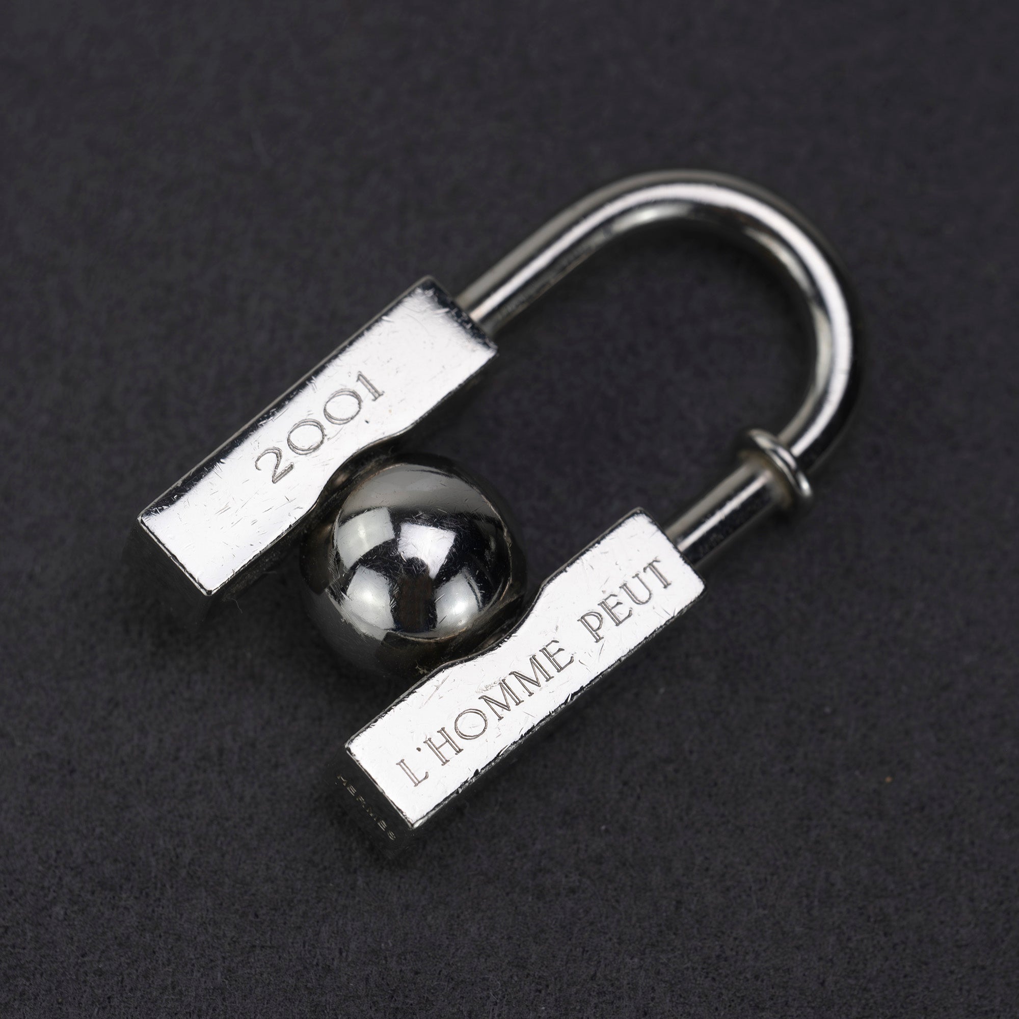 HERMES Padlock Charm 2001 Limited Edition "L'HOMME PEUT EMBELLIR LA TERRE/In Search of the Unknown Beauty of the Earth"