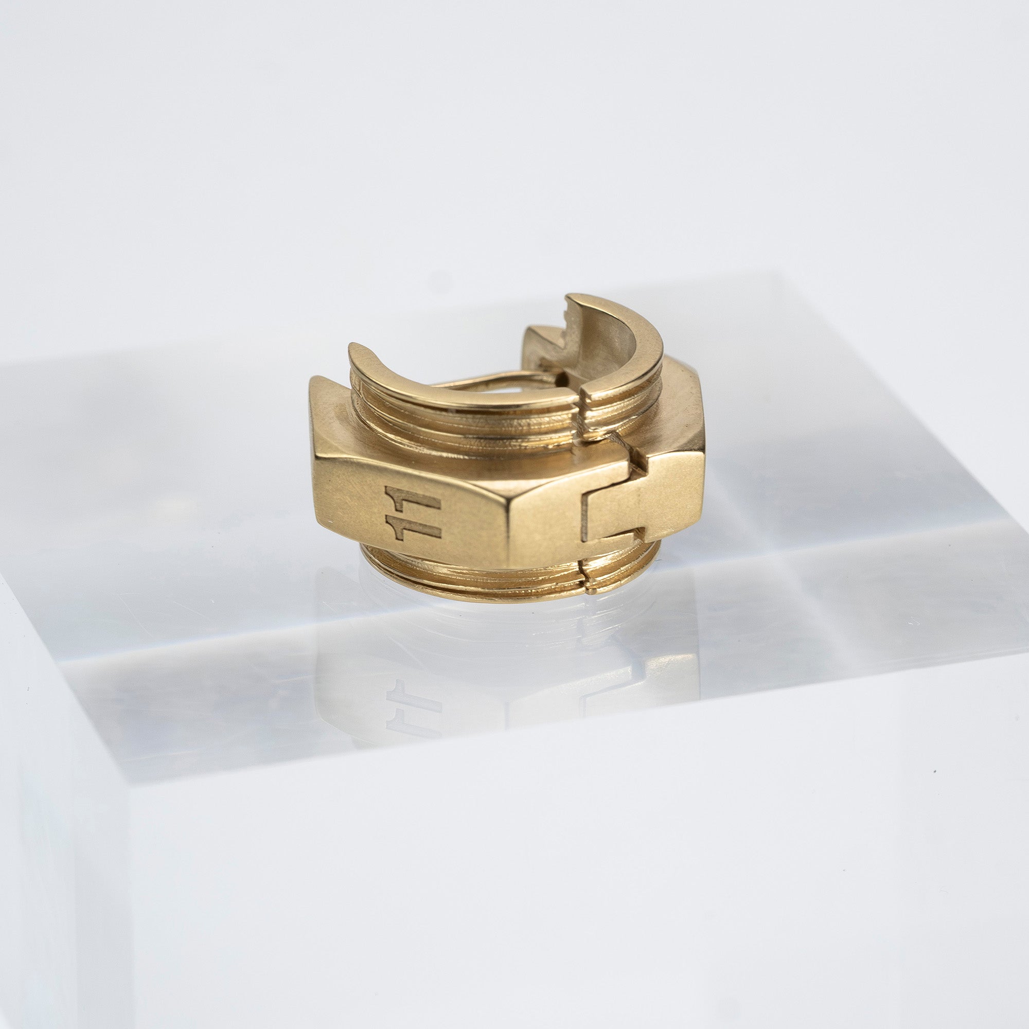 Maison Margiela single earring in 11k gold and brass with bolt motif