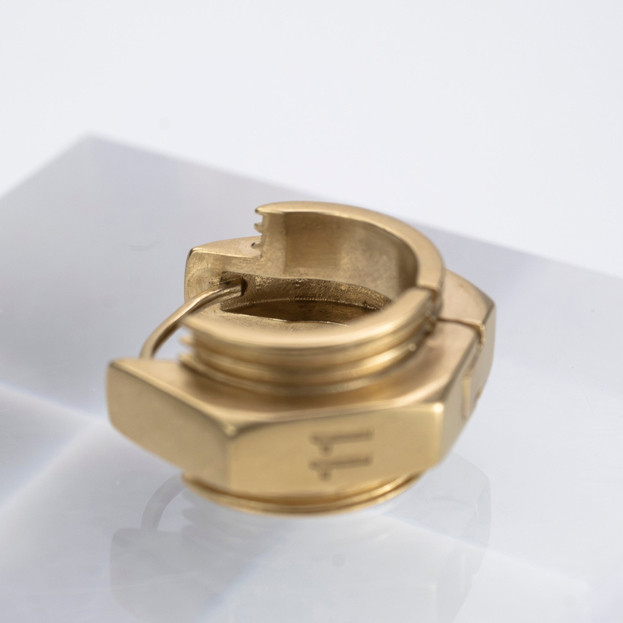Maison Margiela single earring in 11k gold and brass with bolt motif