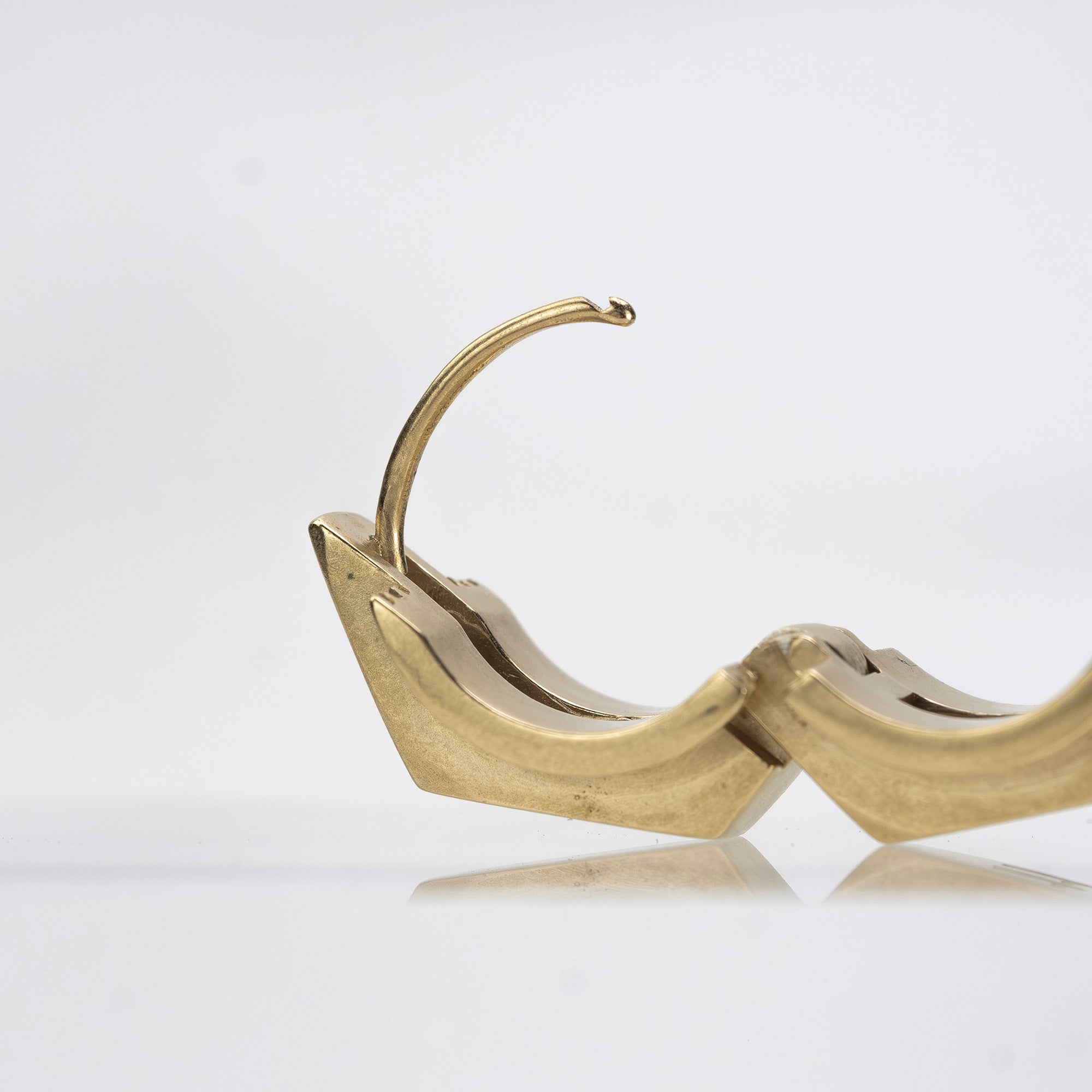 Maison Margiela single earring in 11k gold and brass with bolt motif