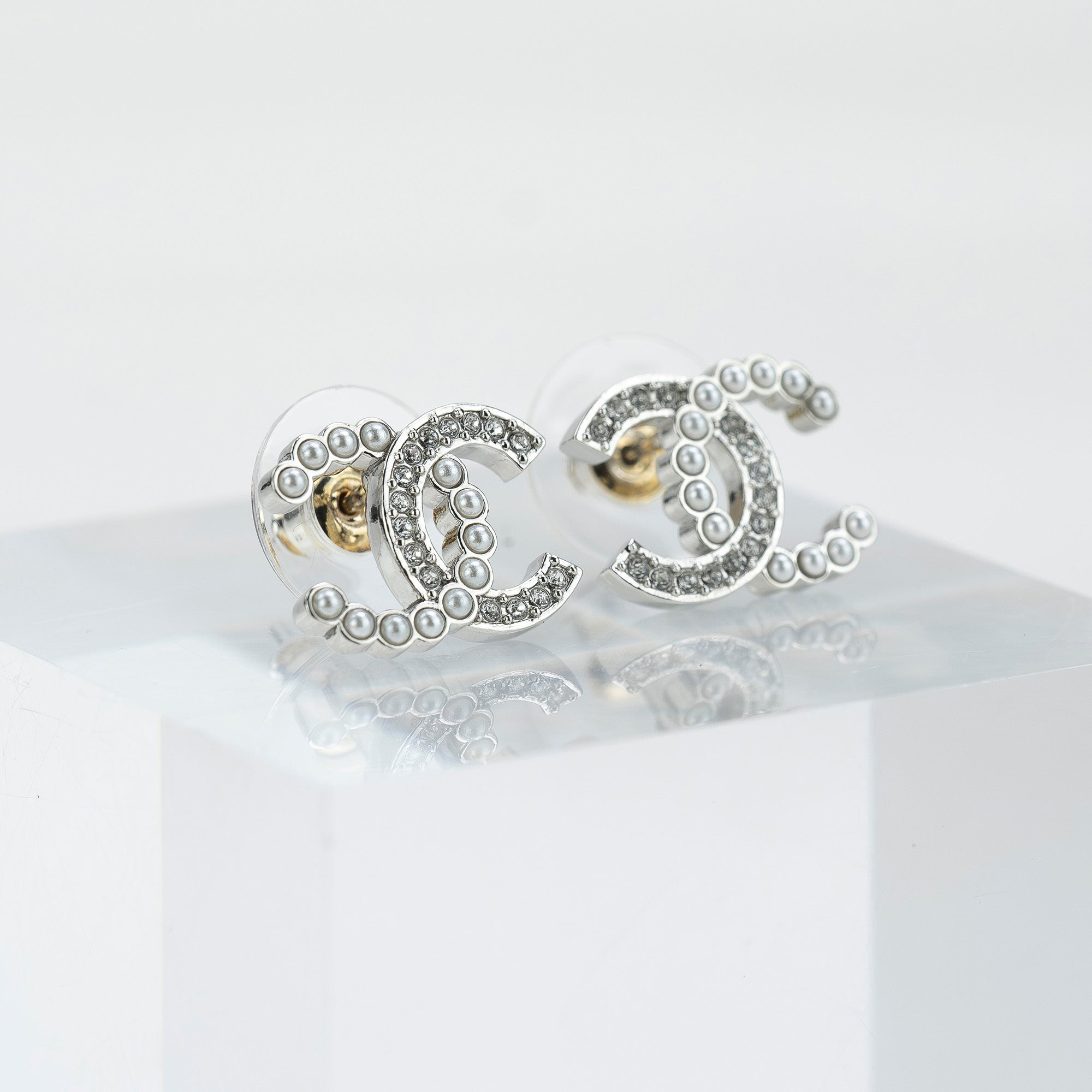 CHANEL Coco Mark earrings with pearls and rhinestones in silver with CC logo. Excellent condition. Comes with box, dust bag, and shopping bag.