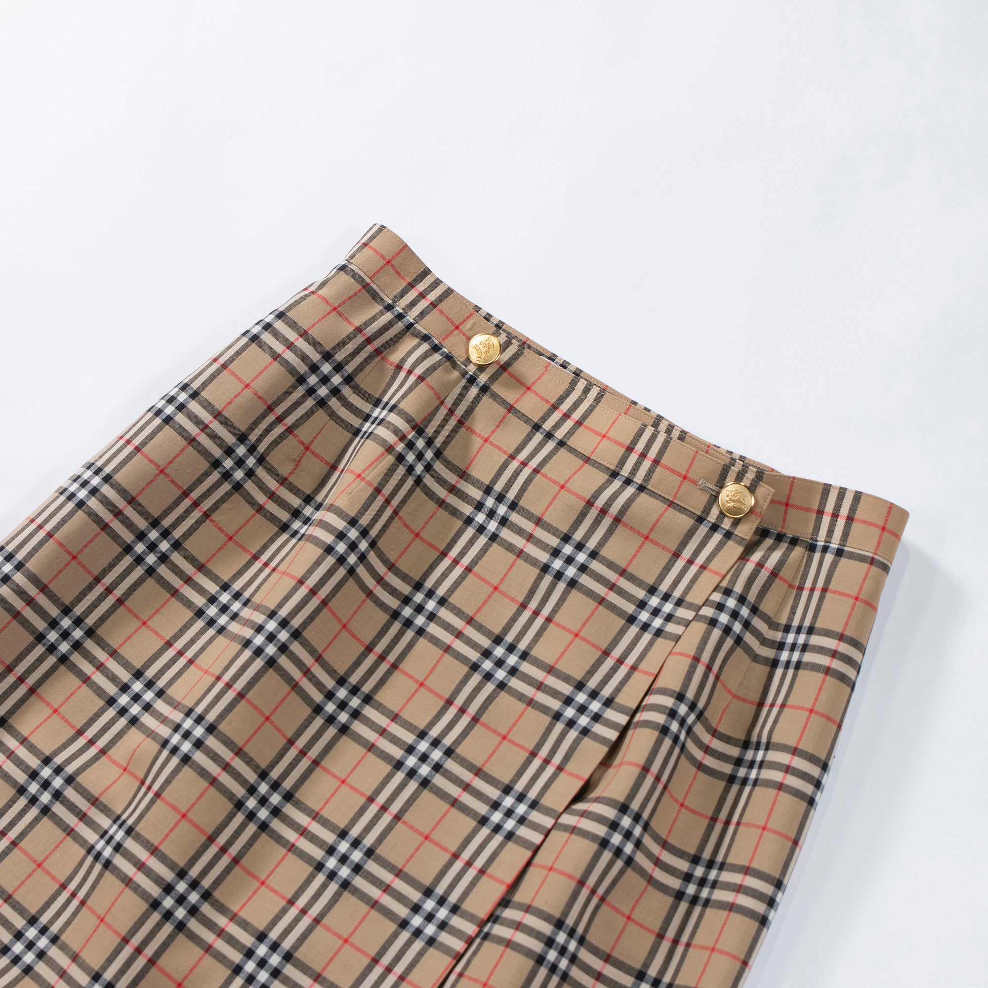 Used Burberry wrap skirt in a Burberry check or Nova check pattern. 100% wool. This wrap skirt is a Burberry women's fashion item from the 1990s.