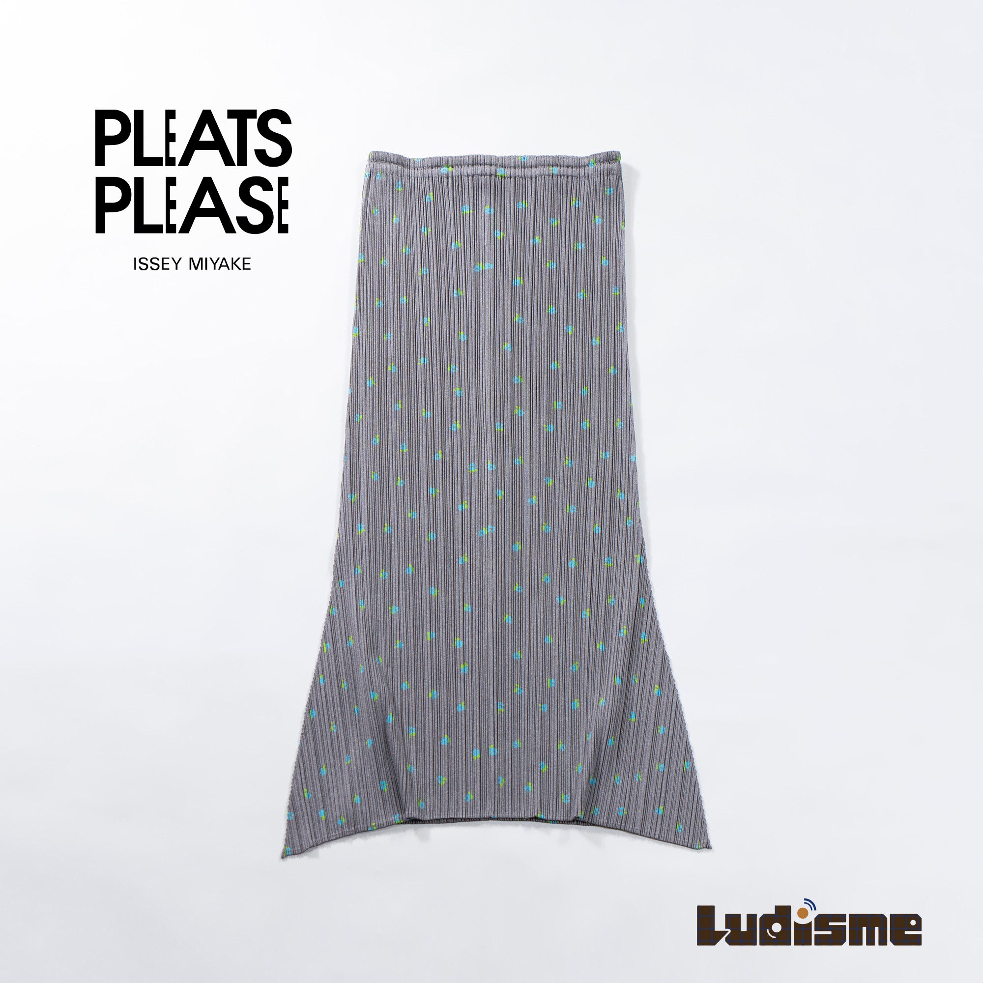 Used PLEATS PLEASE ISSEY MIYAKE side-slit skirt in gray with a floral print. Women's bottoms.