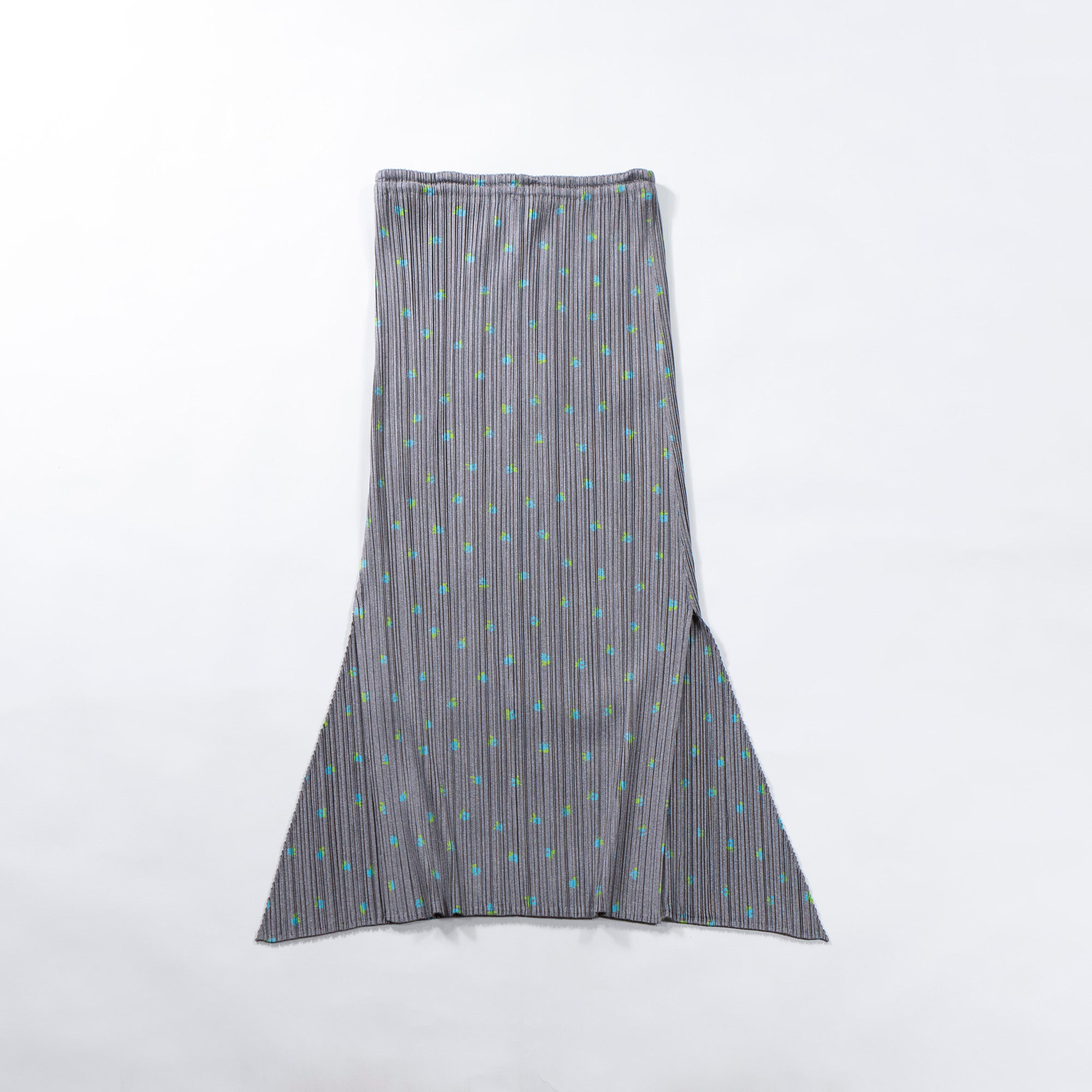 Used PLEATS PLEASE ISSEY MIYAKE side-slit skirt in gray with a floral print. Women's bottoms.