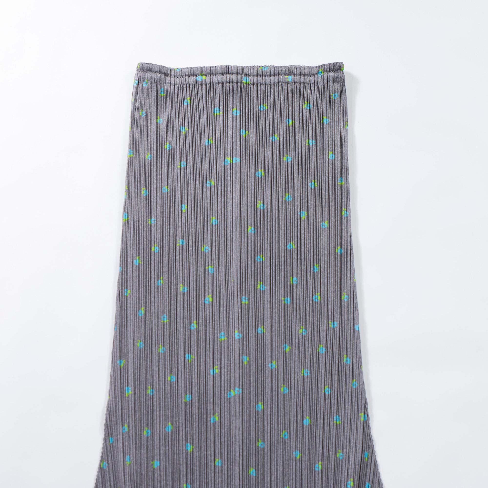 Used PLEATS PLEASE ISSEY MIYAKE side-slit skirt in gray with a floral print. Women's bottoms.