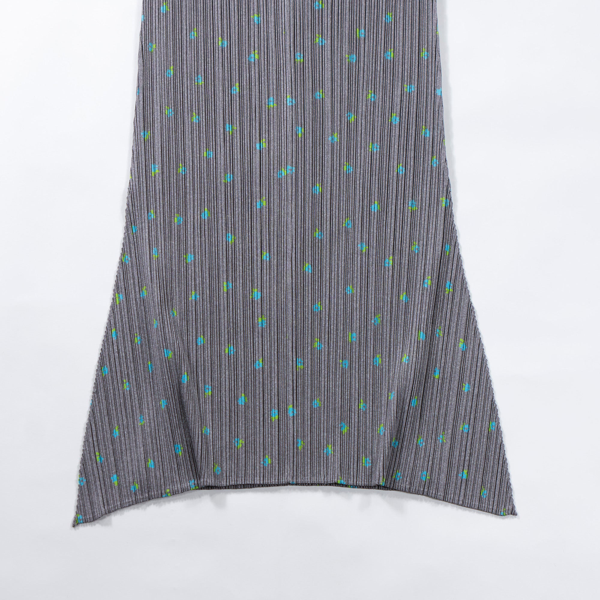 Used PLEATS PLEASE ISSEY MIYAKE side-slit skirt in gray with a floral print. Women's bottoms.