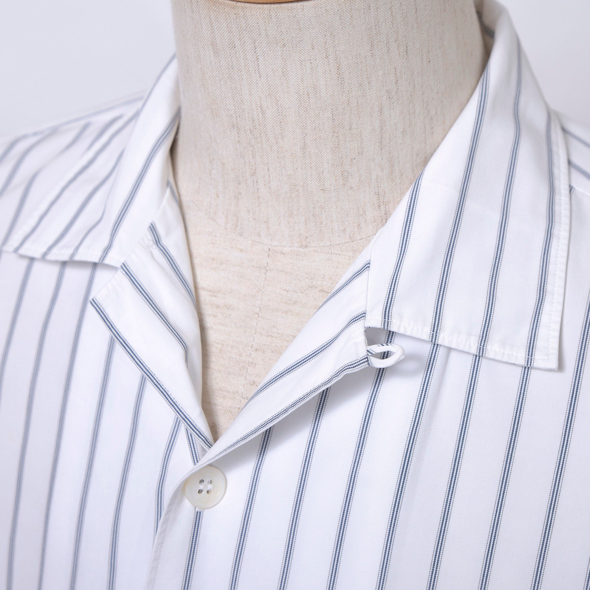 Comme des Garçons striped shirt with a boxy silhouette and long sleeves. This 90s white shirt features an open collar and is designed by Keiichi Tanaka of Tanaka Homme.
