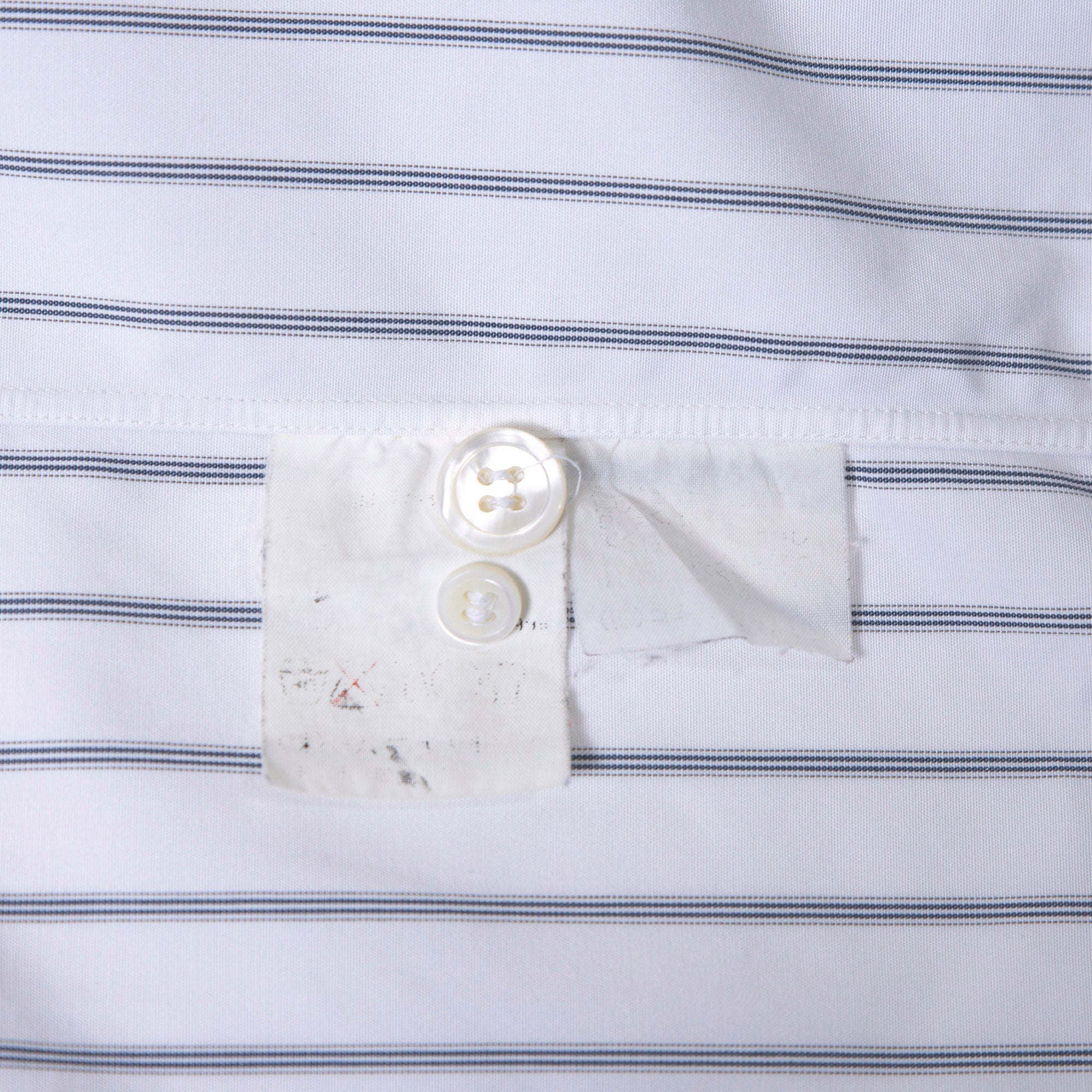 Comme des Garçons striped shirt with a boxy silhouette and long sleeves. This 90s white shirt features an open collar and is designed by Keiichi Tanaka of Tanaka Homme.