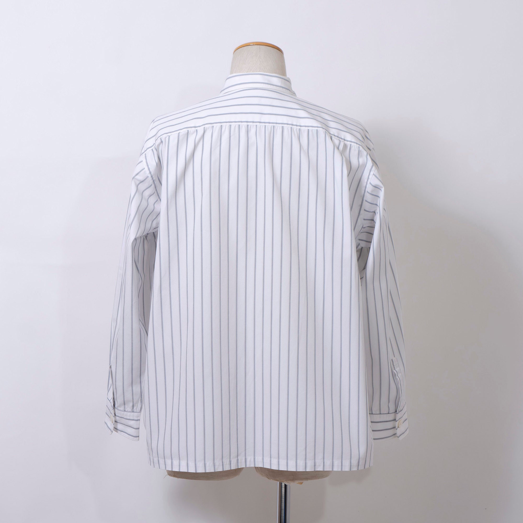 Comme des Garçons striped shirt with a boxy silhouette and long sleeves. This 90s white shirt features an open collar and is designed by Keiichi Tanaka of Tanaka Homme.