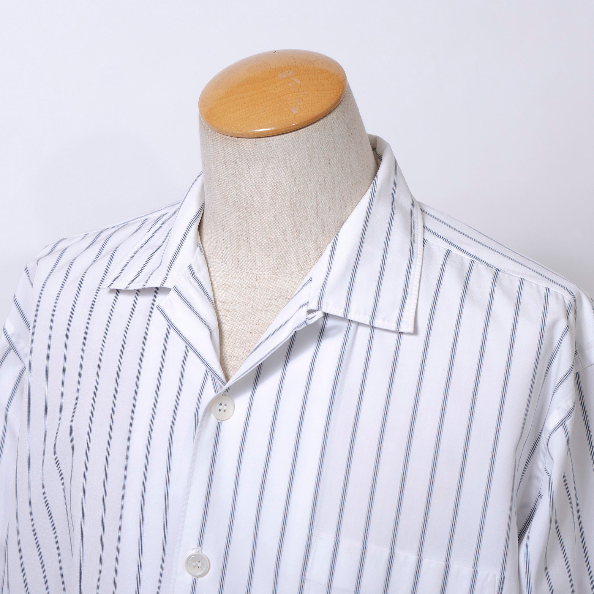 Comme des Garçons striped shirt with a boxy silhouette and long sleeves. This 90s white shirt features an open collar and is designed by Keiichi Tanaka of Tanaka Homme.