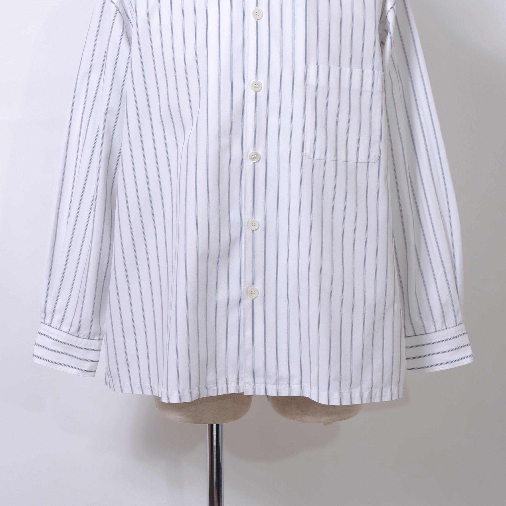 Comme des Garçons striped shirt with a boxy silhouette and long sleeves. This 90s white shirt features an open collar and is designed by Keiichi Tanaka of Tanaka Homme.