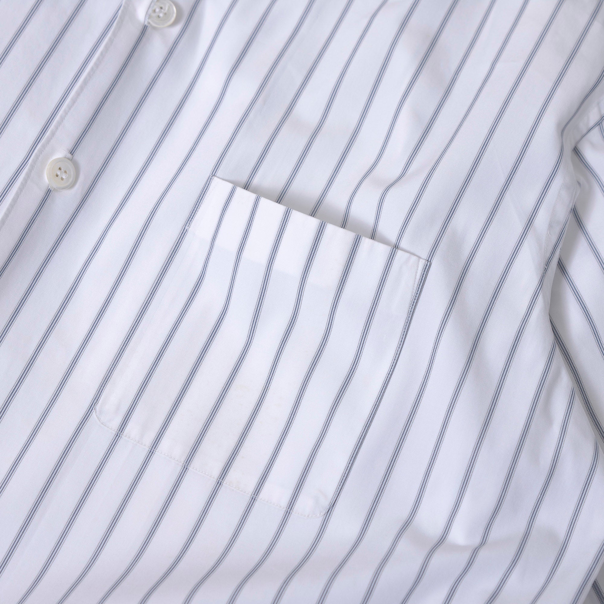 Comme des Garçons striped shirt with a boxy silhouette and long sleeves. This 90s white shirt features an open collar and is designed by Keiichi Tanaka of Tanaka Homme.
