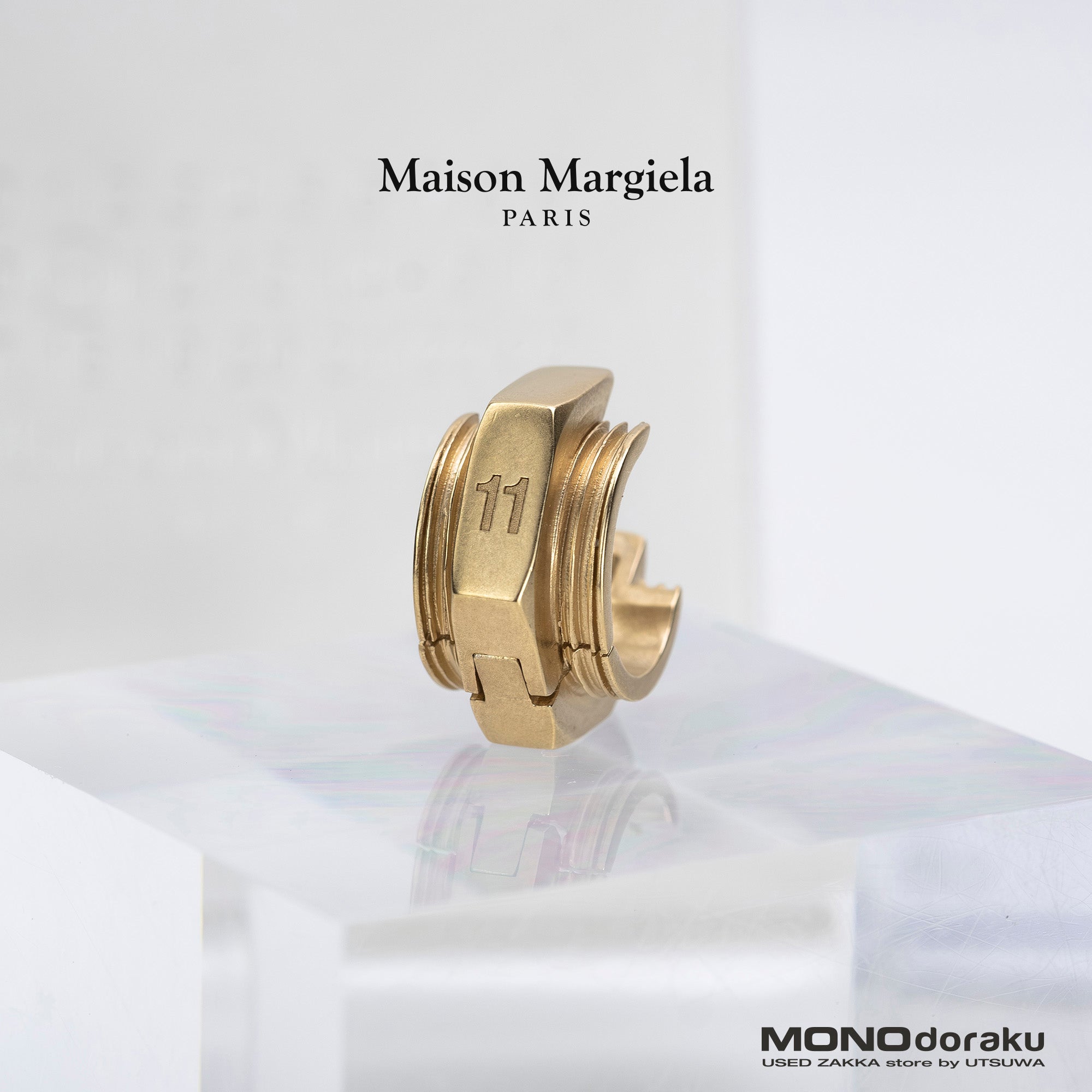 Maison Margiela single earring in 11k gold and brass with bolt motif